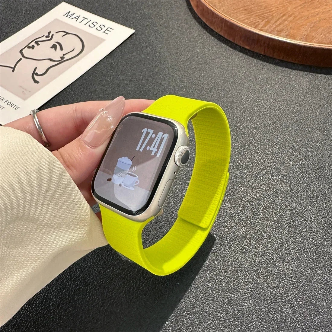 Green magnetic leather loop Apple Watch band on wrist close-up