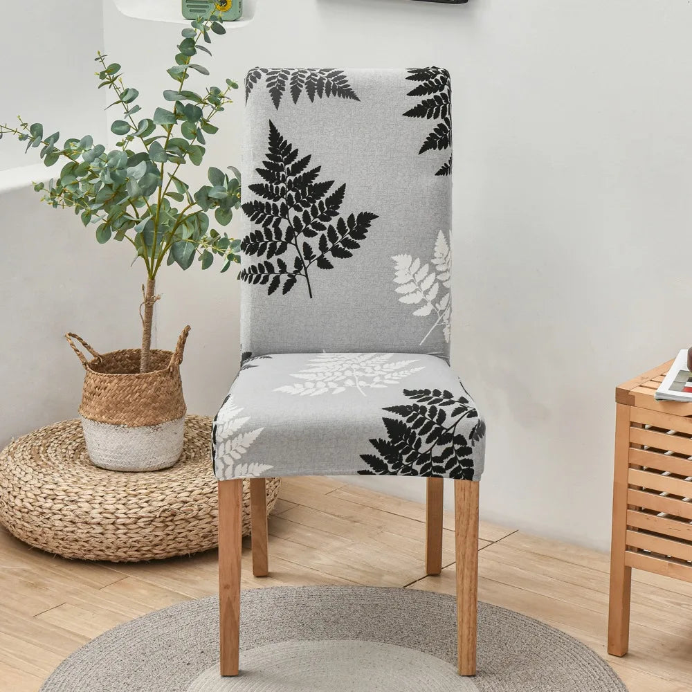 Grqay and white botanical leaf print chair cover with dark legs in living space