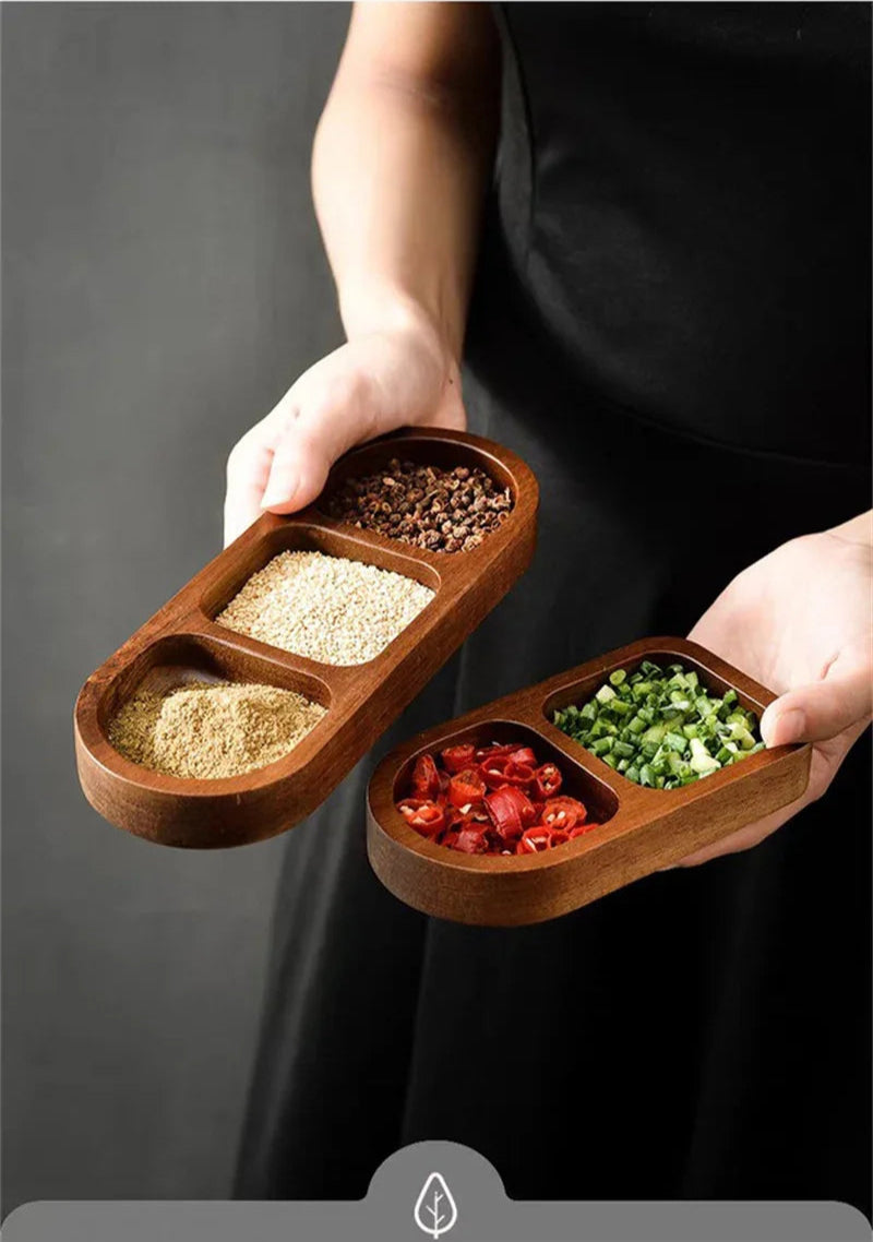 Hands serving condiments using compact wooden tray filled with chili and green onion