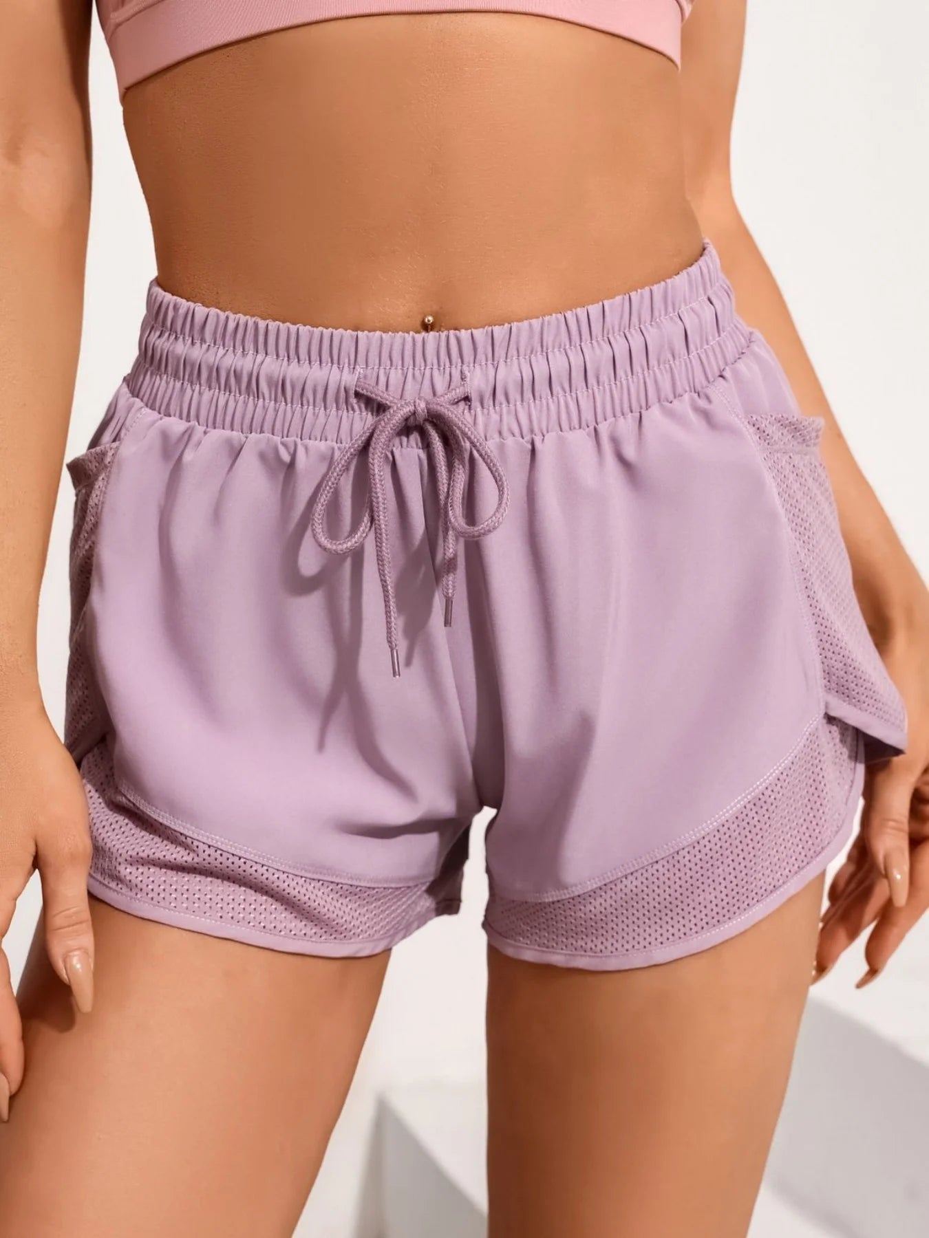 Lavender pink workout shorts with drawstring and mesh side pockets