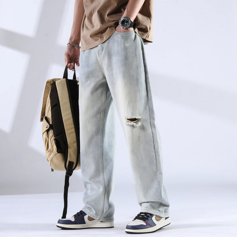 Light ice-wash distressed jeans with worn-in effect, shown from front