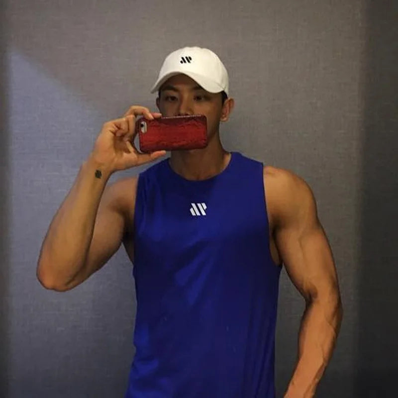 Man in blue quick-dry mesh tank top for workouts, athletic front pose in mirror