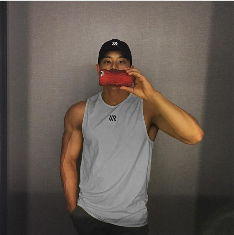 Man in gray quick-dry mesh tank top for workouts, athletic front pose in mirror