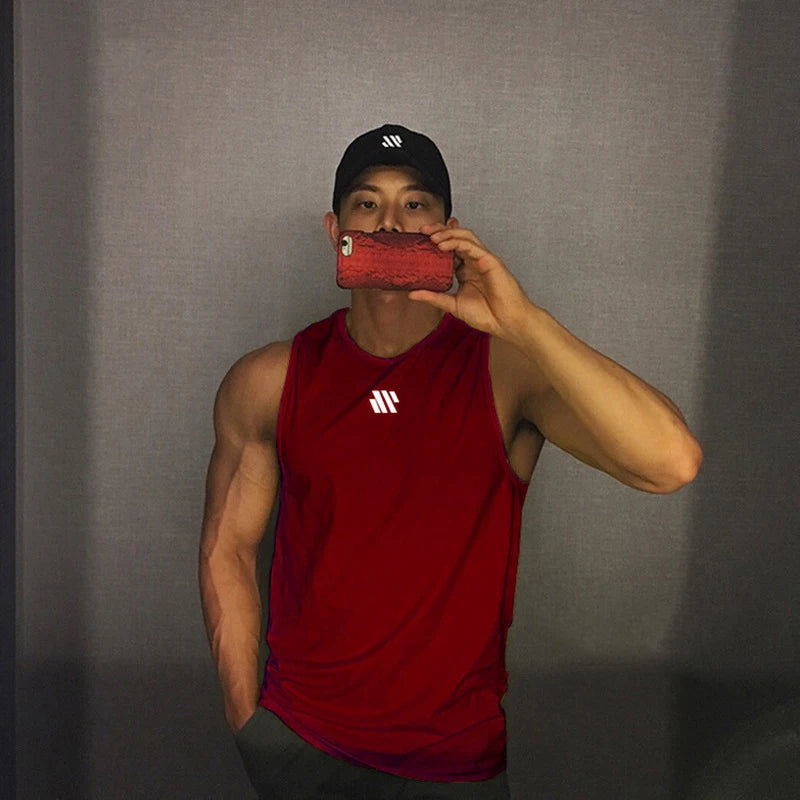 Man in red quick-dry mesh tank top for workouts, athletic front pose in mirror
