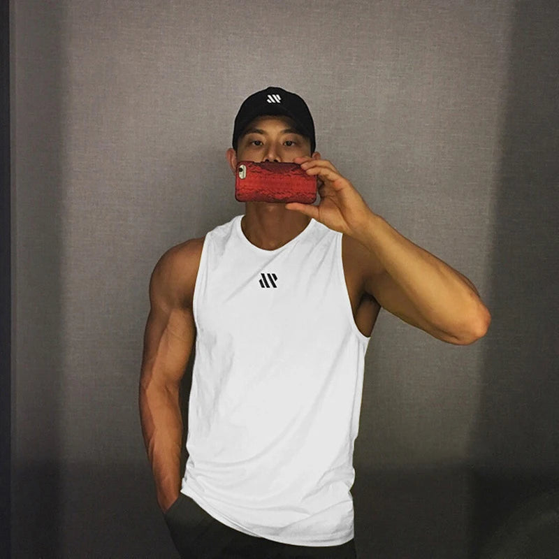 Man in white quick-dry mesh tank top for workouts, athletic front pose in mirror