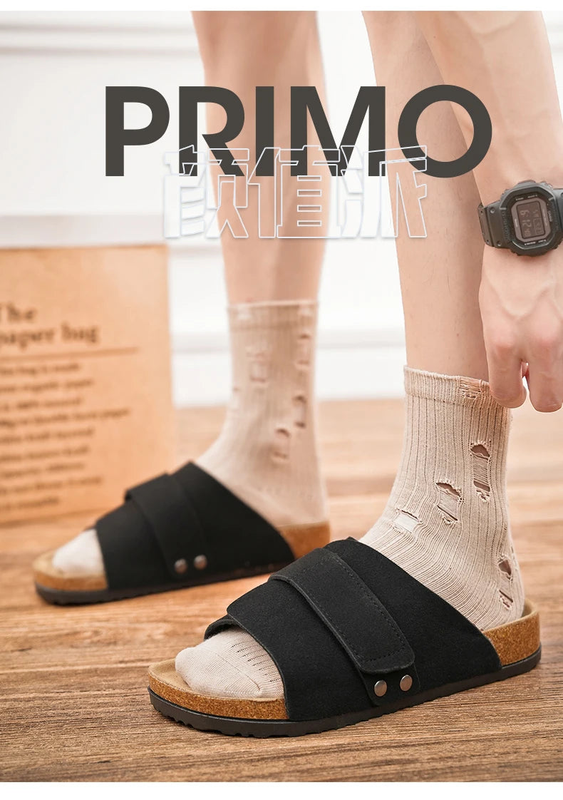 Man wearing black adjustable suede sandals with cork footbed, wooden floor background