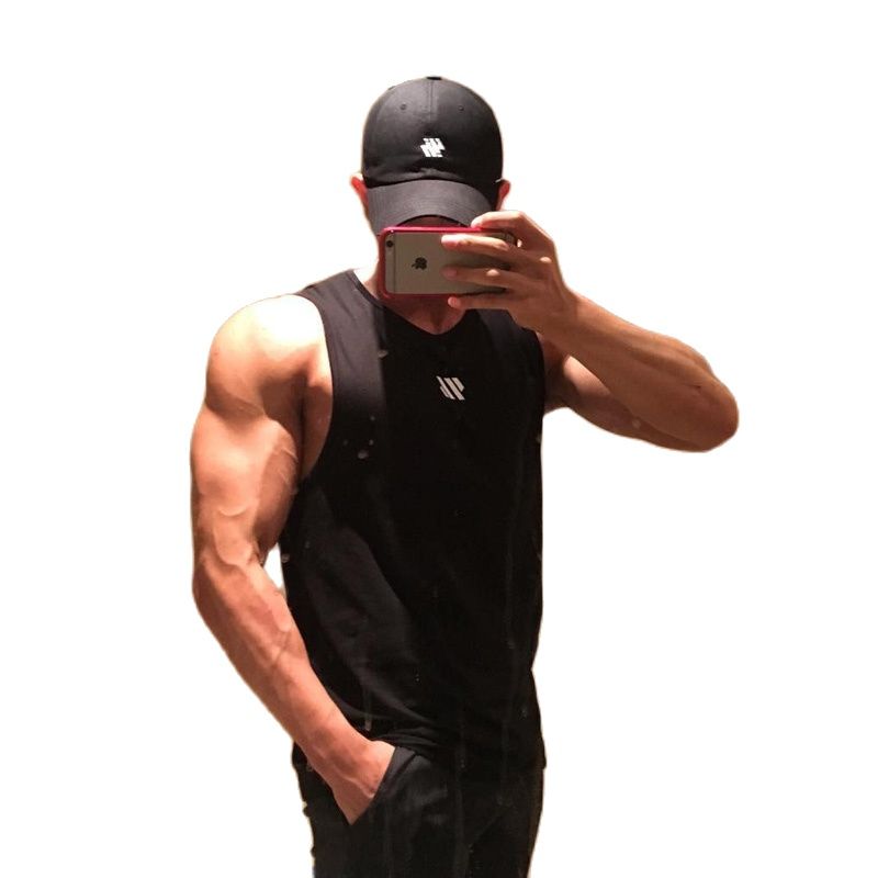 Man wearing black mesh gym tank top and cap, isolated on white background with mirror selfie pose