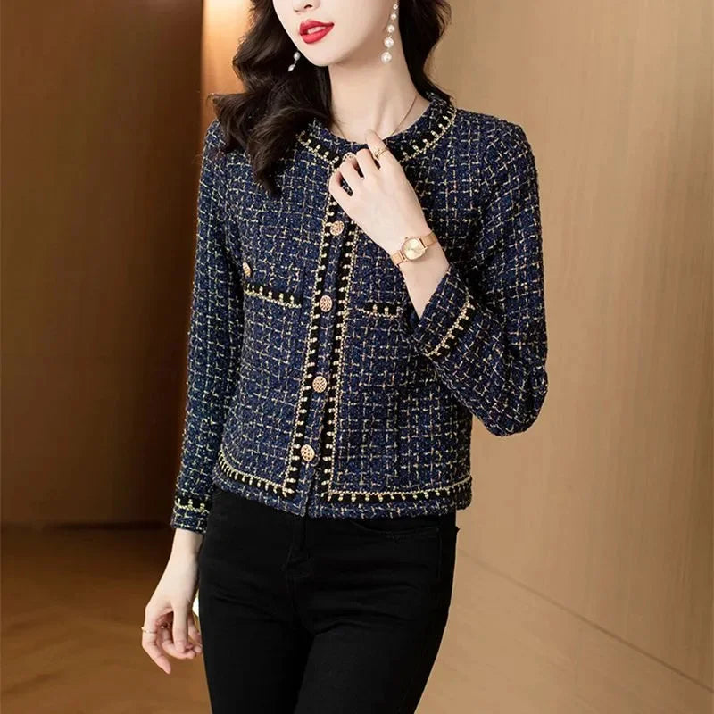 Model adjusting jacket front, showing gold button closure