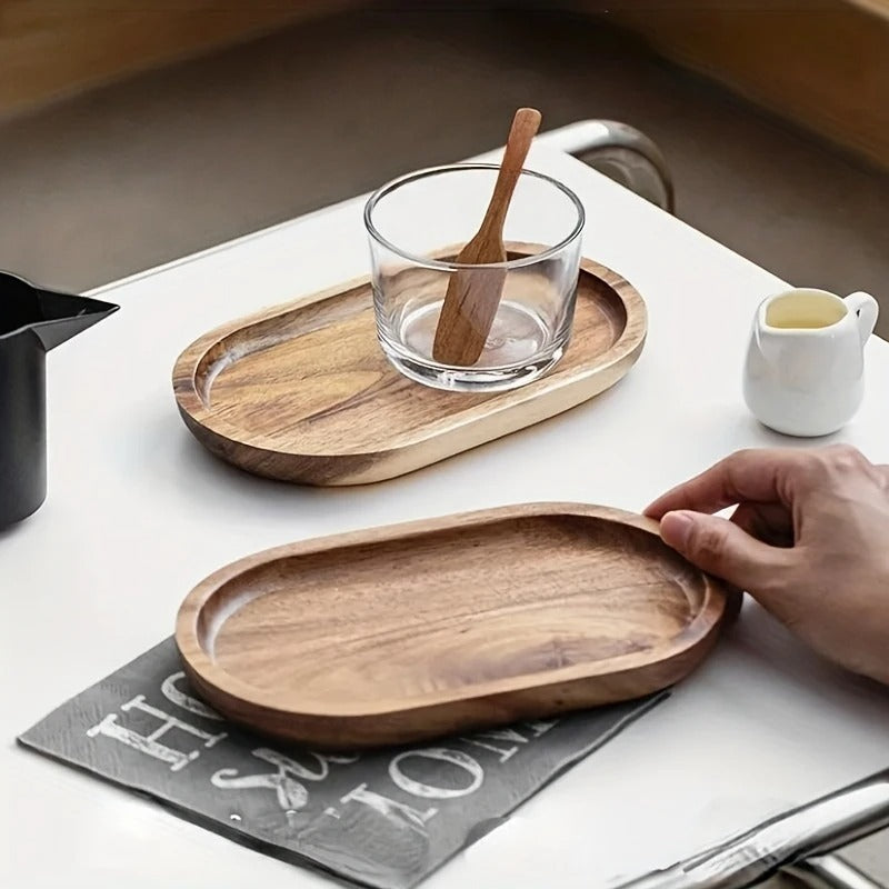 Mokura oval tray with clear glass and wooden spoon beside mini milk jug on white café table