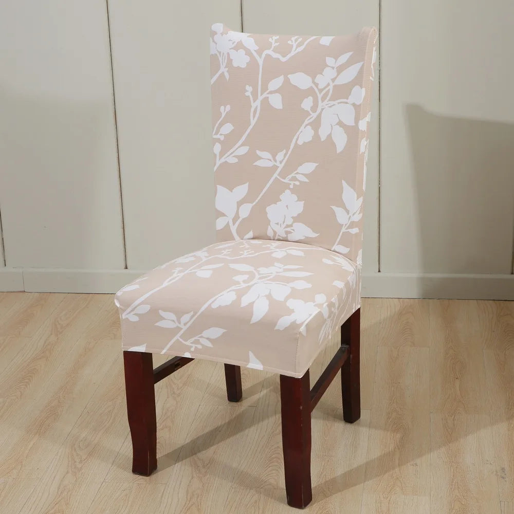 Neutral beige chair cover with white botanical vine pattern in softly lit room