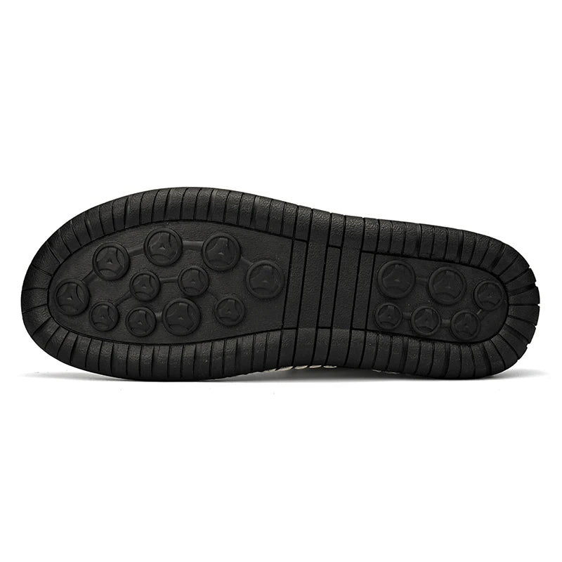 Non-slip rubber outsole of men's sneaker with round grip pattern, flat lay