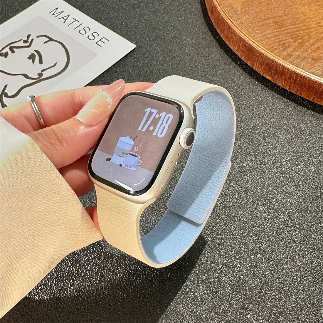 Orange magnetic leather loop Apple Watch band on wrist close-up