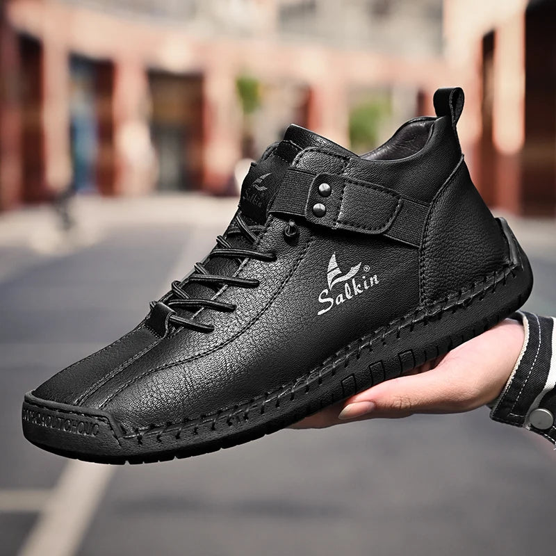 Outdoor scene with black breathable ankle sneakers held in hand, casual style