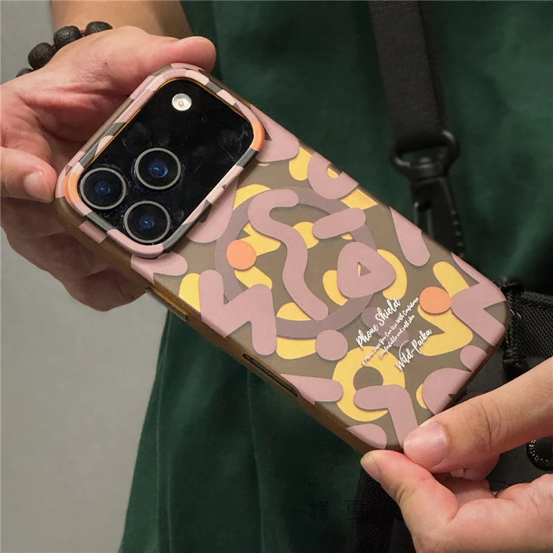 Person holding brown graffiti MagSafe iPhone 17 case showing slim edge
