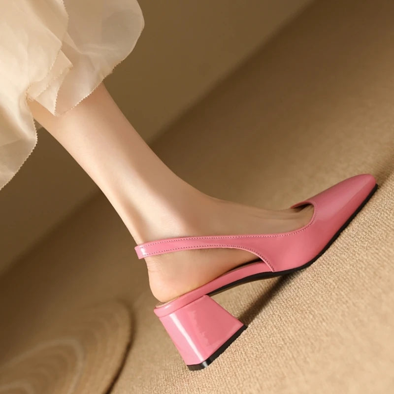 Pink patent leather slingback heels showing heel and strap design, side view