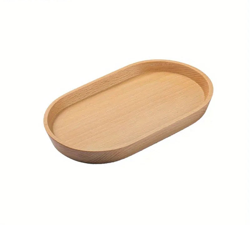 Plain oval wooden tray in light finish on white background, angled view