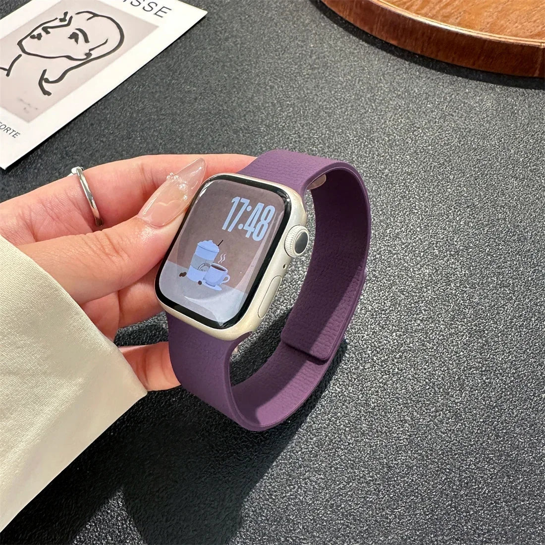 Purple magnetic leather loop Apple Watch band on wrist close-up