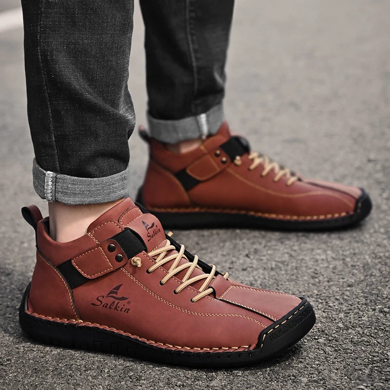 Red-brown men's casual leather sneakers with breathable stitching, worn outdoors
