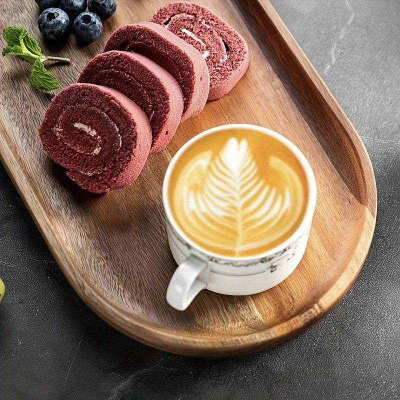 Red velvet roll cake and latte on Mokura wood tray, styled with blueberries and mint on dark tabletop