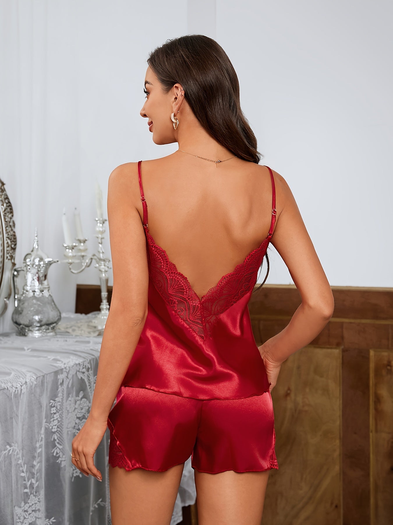 Ruby red satin pajama set with lace shorts, standing back view