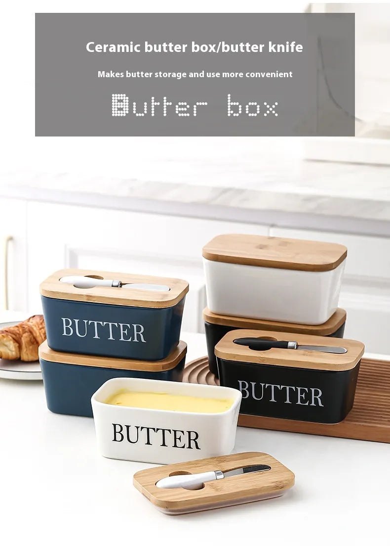 Set of colorful ceramic butter dishes in white, navy blue, and black with bamboo lids and spreaders, front view