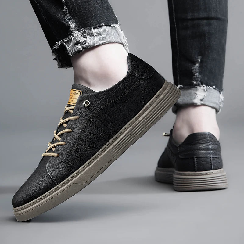 Side and rear view of black leather sneakers with rubber soles in casual setting
