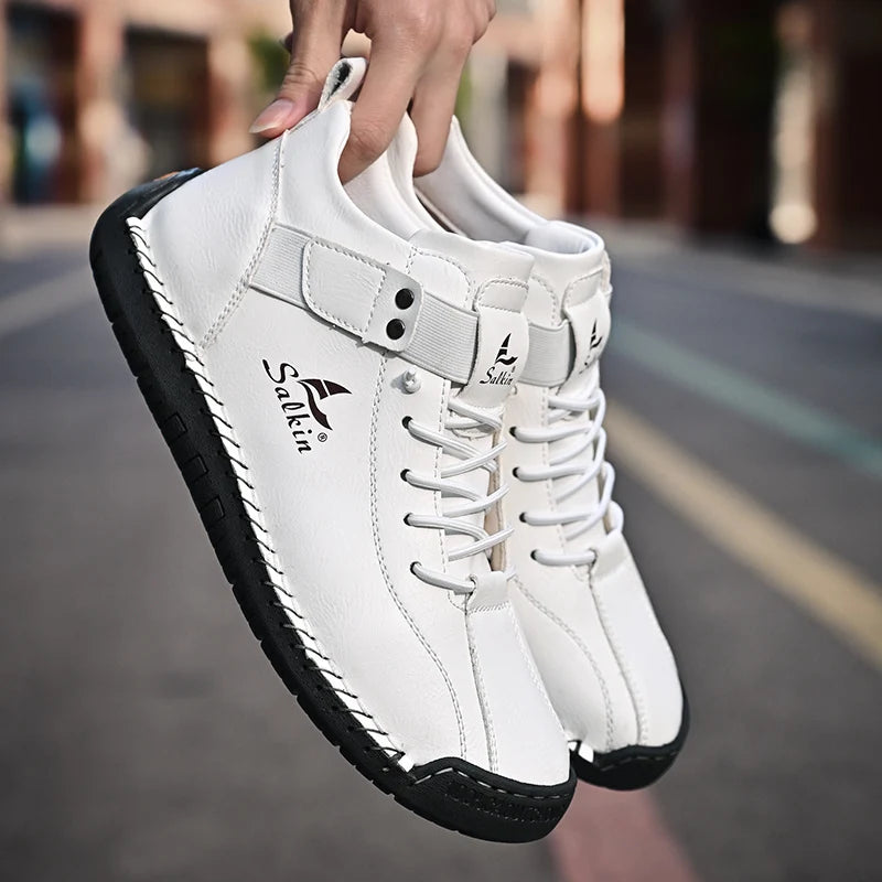 Side view of breathable brown handmade sneakers with stitched edge and pull tab