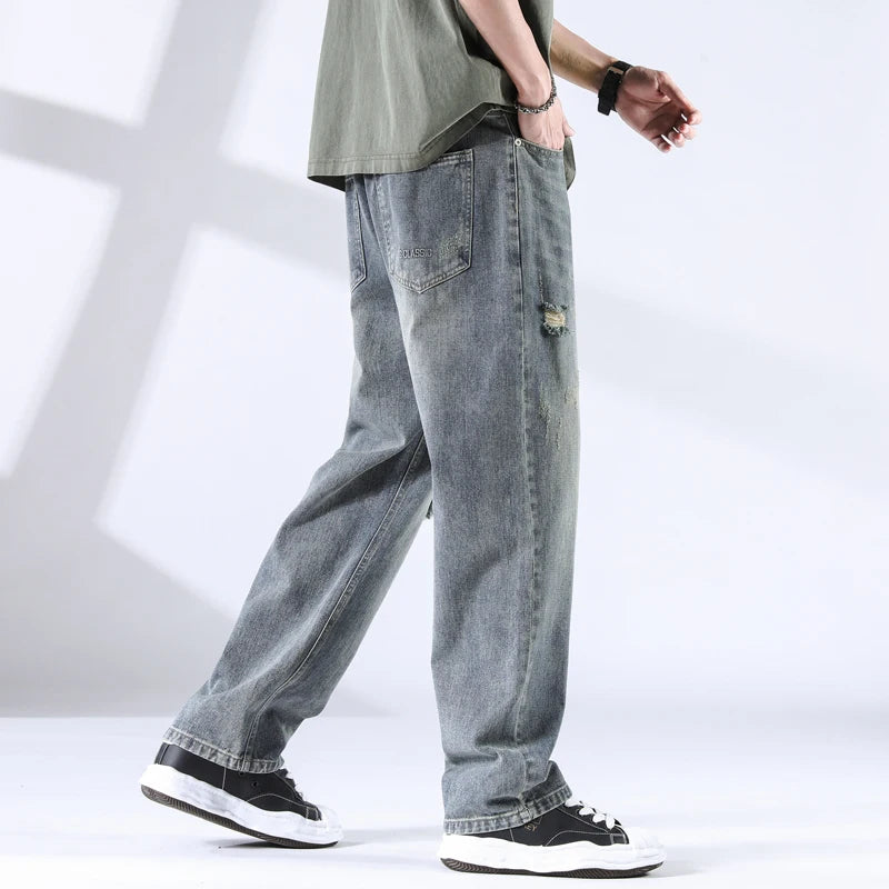 Stone washed denim jeans from rear angle, showing back pocket detail