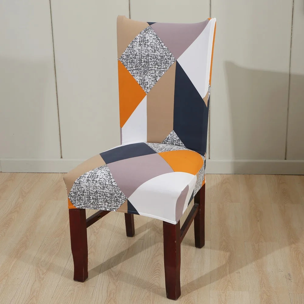Stretch chair cover with bold geometric pattern in orange, beige, and navy blocks