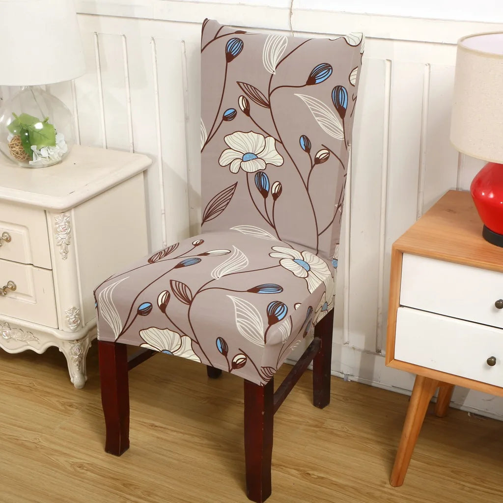 Taupe stretch chair cover with brown and blue floral print near vintage nightstand