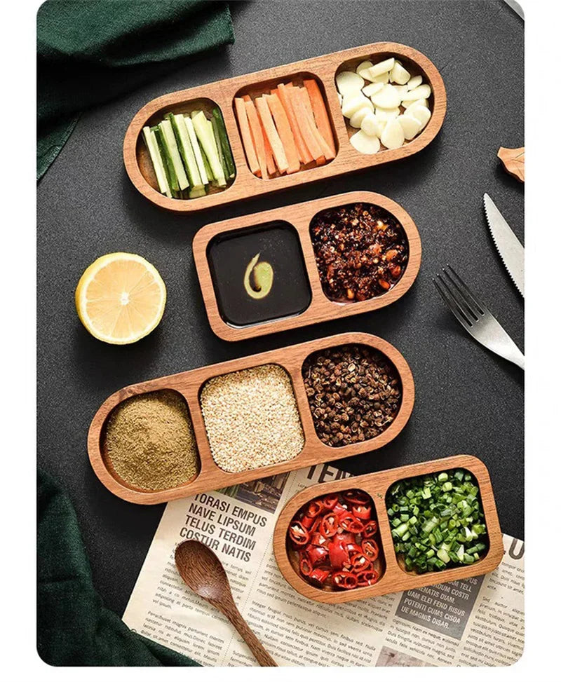 Top-down view of three wood condiment trays filled with sliced vegetables and sauces