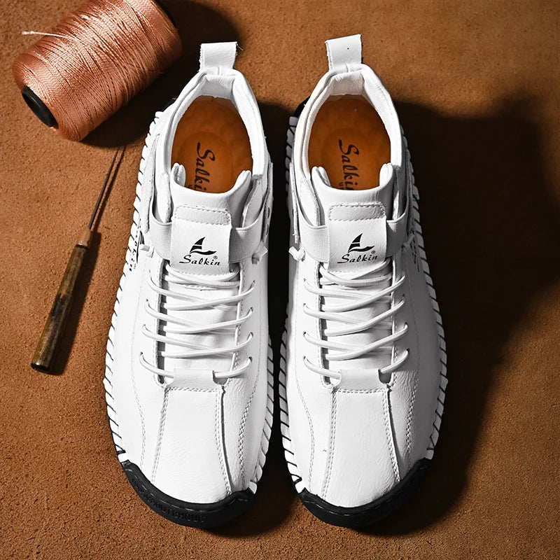 Top-down view of white leather sneakers with wide opening and breathable structure