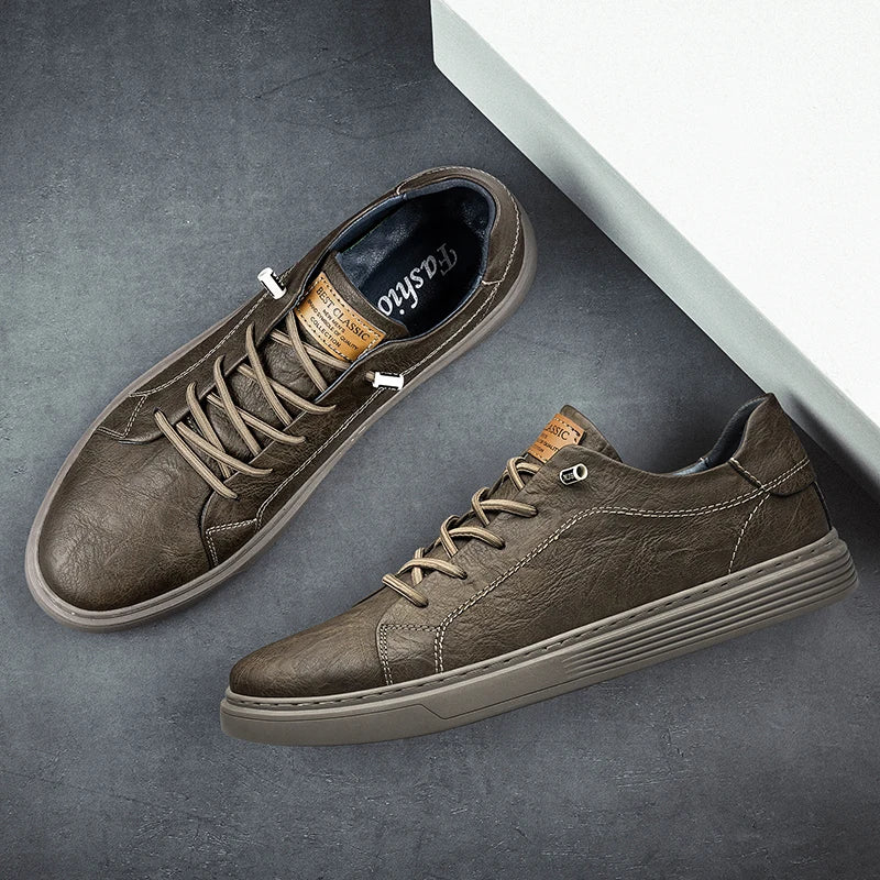 Top and side view of taupe brown leather sneakers with textured finish on grey background