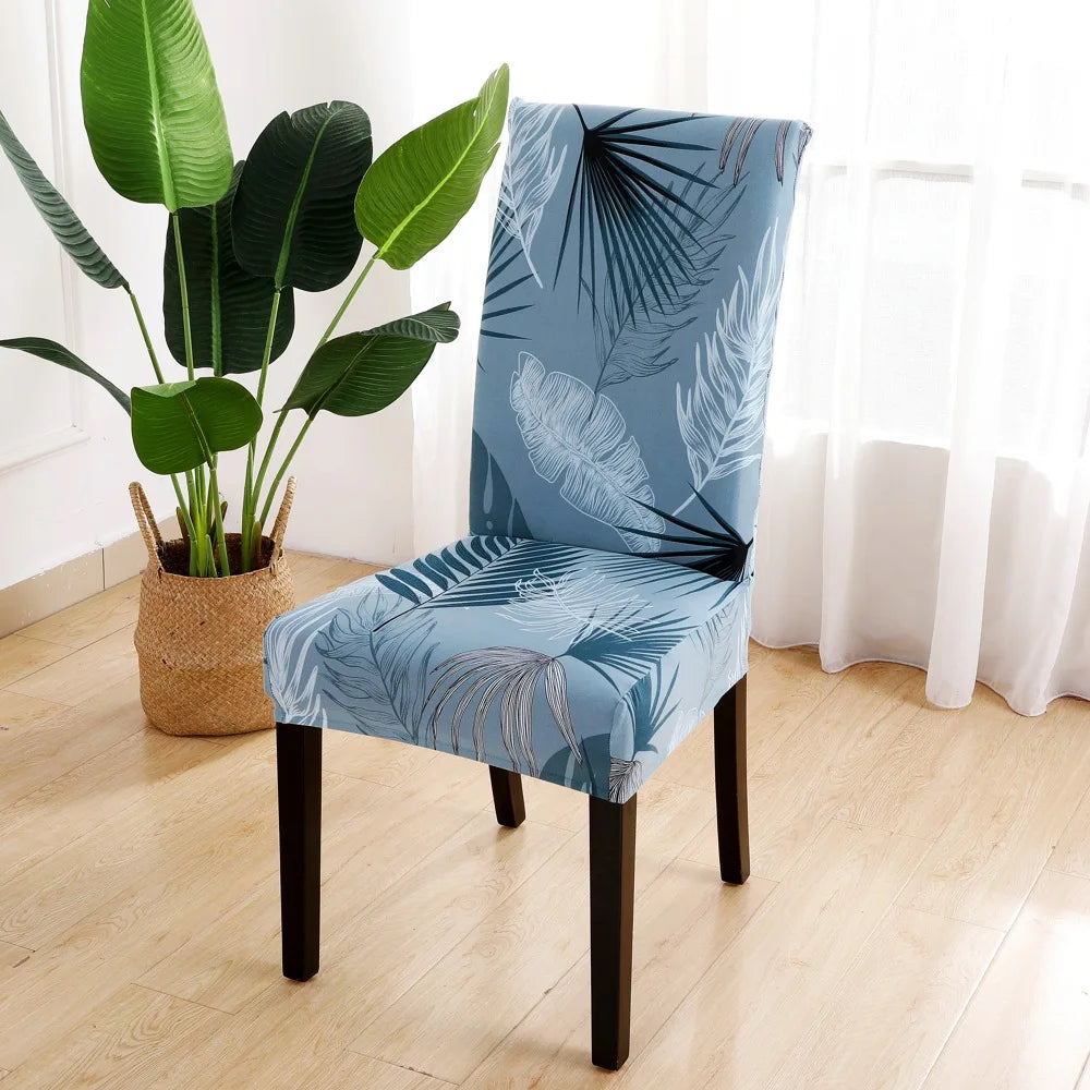 Tropical leaf patterned blue chair cover in bright natural light with plant decor