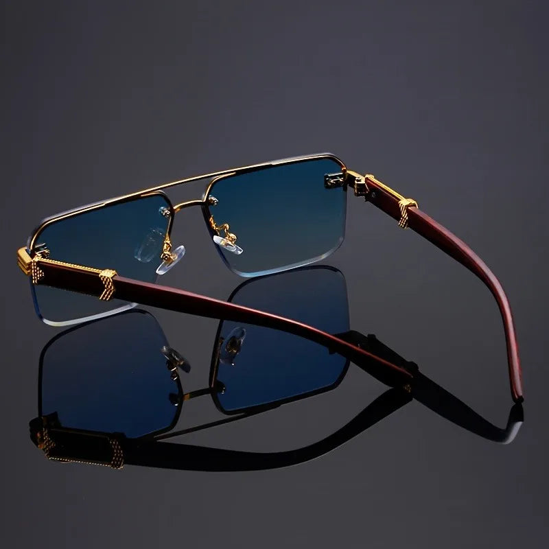 Two frameless sunglasses in black and blue lens options, side-by-side on black surface