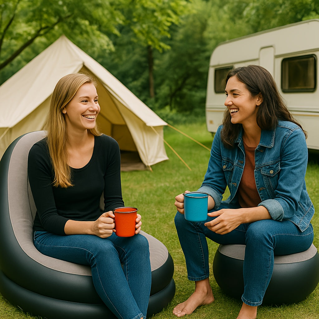 Two women sitting and chatting on inflatable loungers beside a caravan