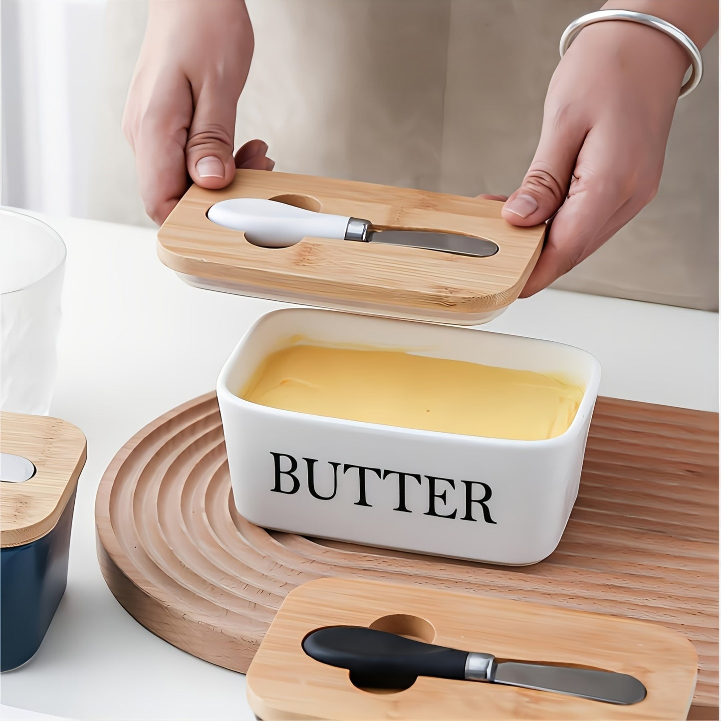 White butter dish with bamboo lid, knife slot shown in use