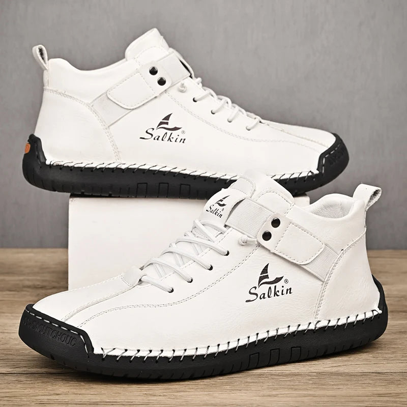 White handmade ankle sneakers with breathable fit and stitched sole, studio shot