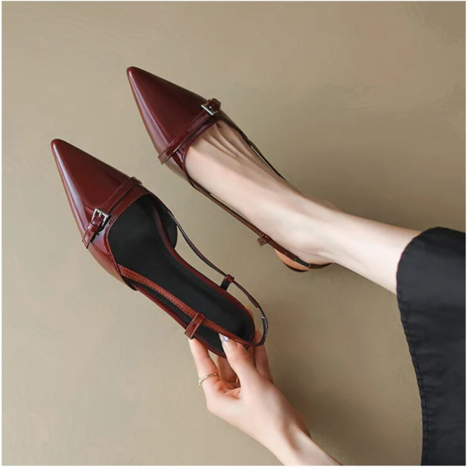 Wine red patent pointed-toe slingback heels with buckle detail, angled view