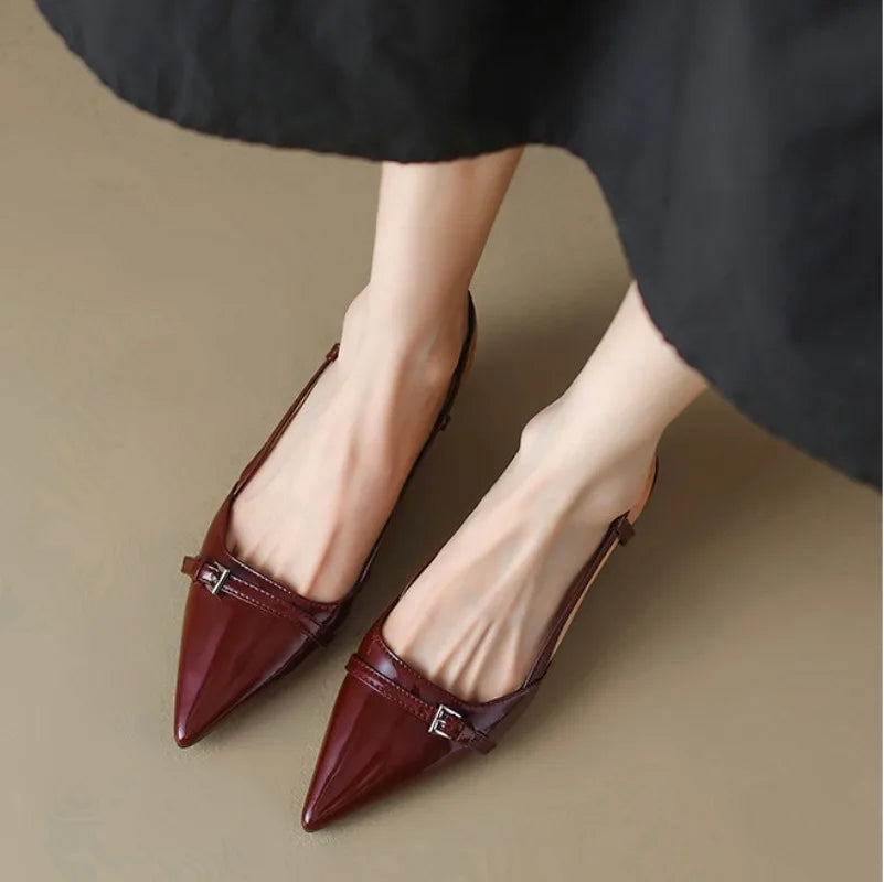 Wine red slingback heels worn with skirt, top-down view