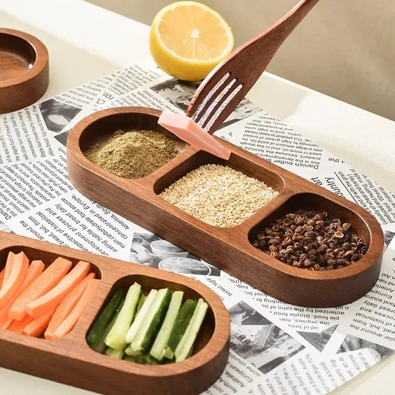 Wooden condiment trays filled with garlic, carrots, cucumbers, green onion, and chili peppers