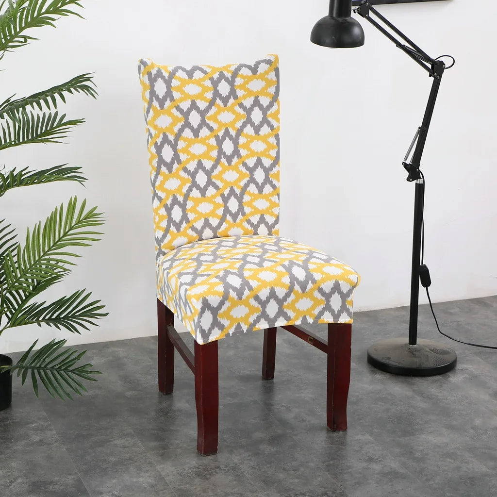 Yellow and gray Ikat-style tribal print chair cover in monochrome interior with potted plants