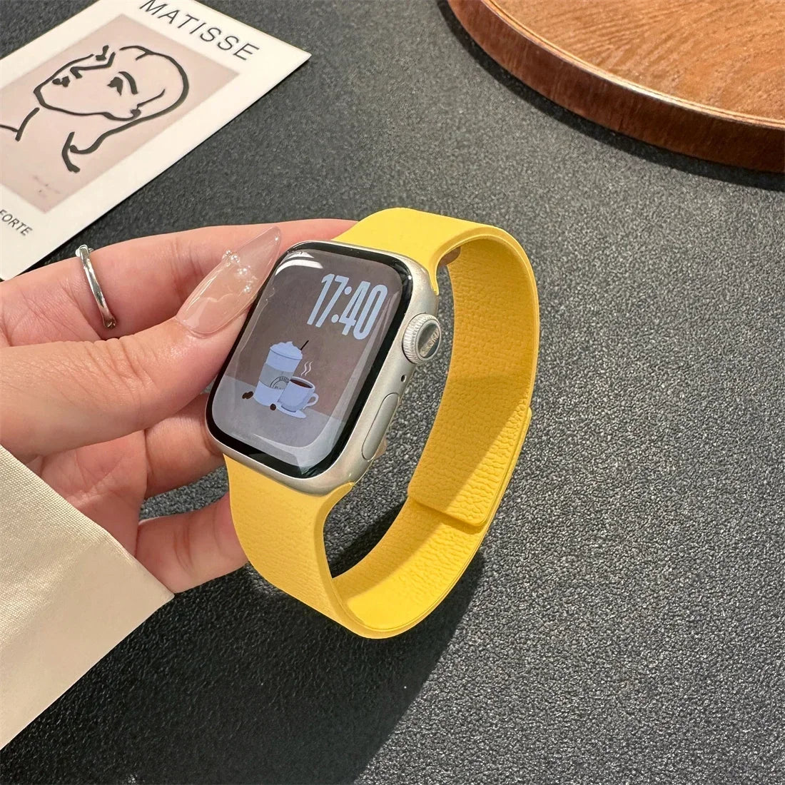 Yellow magnetic leather loop Apple Watch band on wrist close-up