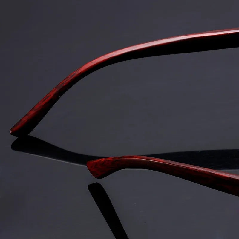 Zoomed-in hinge and gold arm detailing with faux woodgrain texture on sunglasses