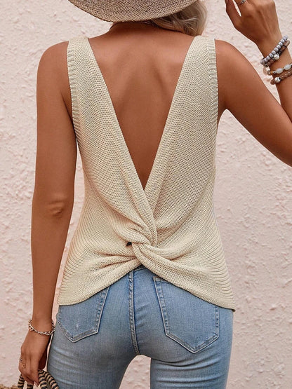 Back view of ivory twist-back sleeveless knit top with deep V-shaped open back and knot detail