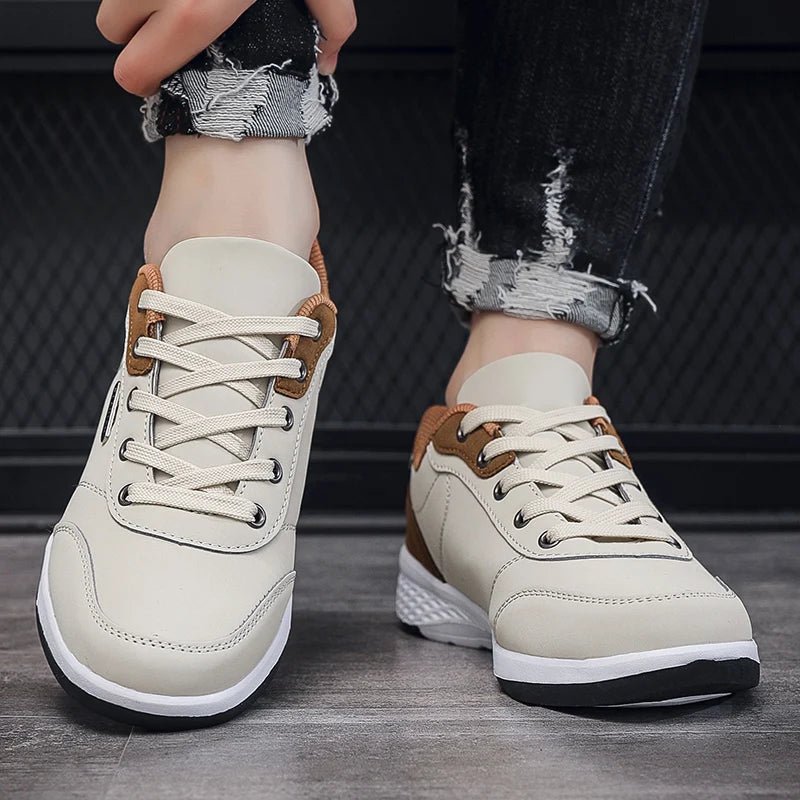 Beige and brown sneaker on foot beside tan wood wall