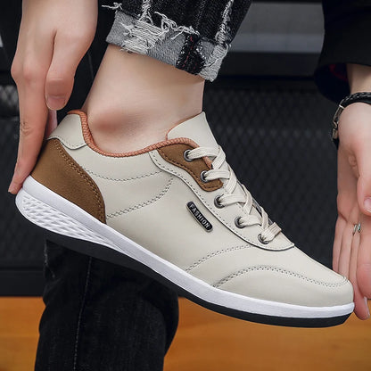 Beige and brown sneakers, hand-held close-up display, side view