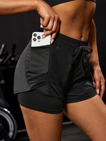 Black athletic shorts with deep pocket, gym background