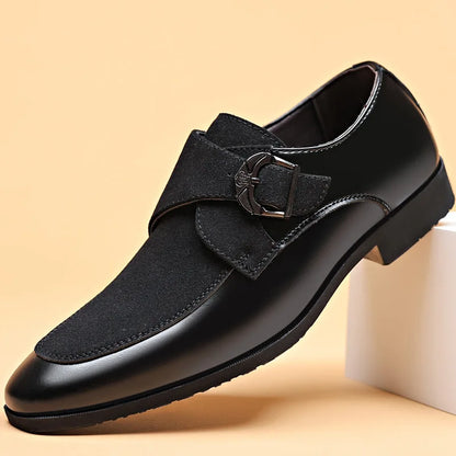 Black men’s leather loafers with pointed toe and metal buckle close-up