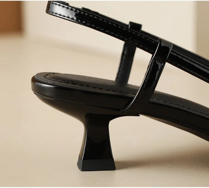 Black slingback heel, close-up of buckle strap